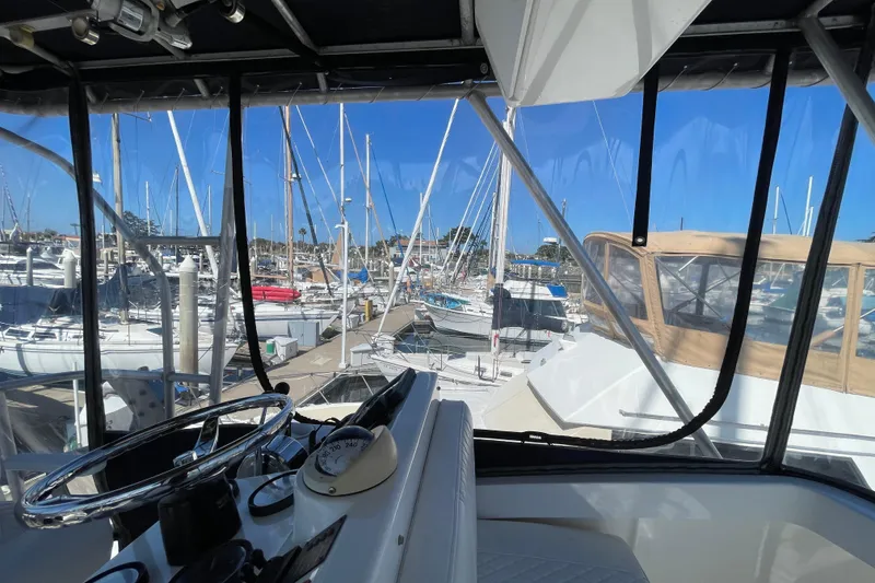 Slide: The Image of View from 2003 Luhrs 34 Convertible boat helm overlooking marina with sailboats. - 49
