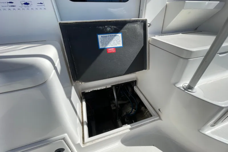 Slide: The Image of 2003 Luhrs 34 Convertible boat interior with open hatch and warning label. - 51