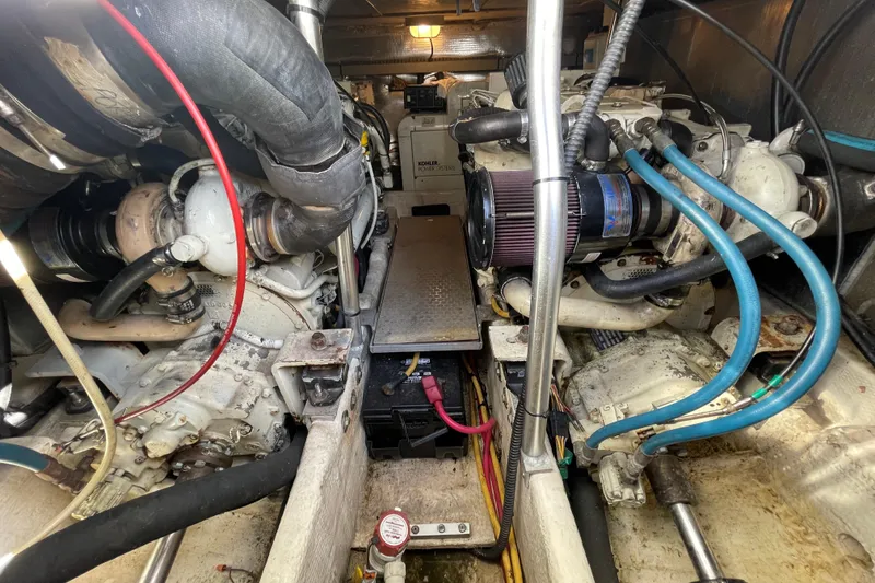 Slide: The Image of Engine room of 2003 Luhrs 34 Convertible boat, showcasing dual engines and mechanical components. - 52
