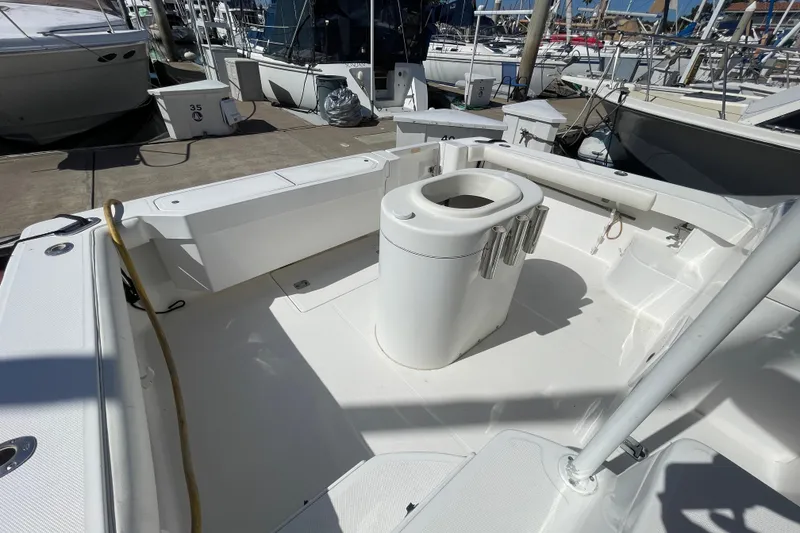 Slide: The Image of 2003 Luhrs 34 Convertible boat deck with fishing rod holders at marina. - 8