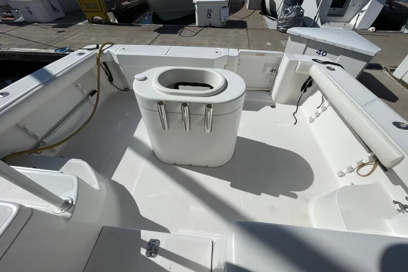 Slide: The Image of 2003 Luhrs 34 Convertible boat deck with fishing rod holders and seating. - 9