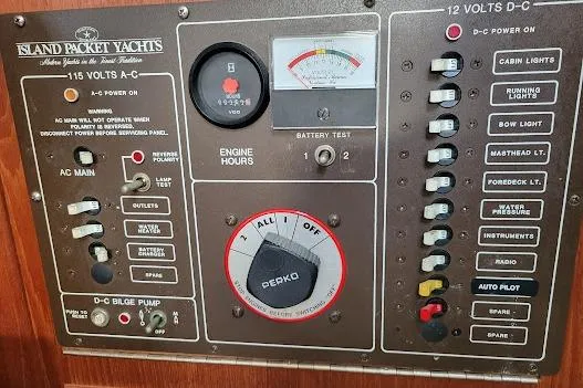 Slide: The Image of Electrical control panel of a 1988 Island Packet 31 yacht with various switches and gauges. - 37