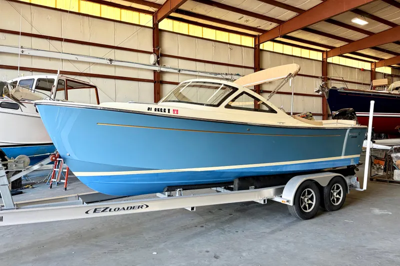 The Image of 2018 Vanquish Bristol Harbor 23 boat on trailer in indoor storage facility. - 1