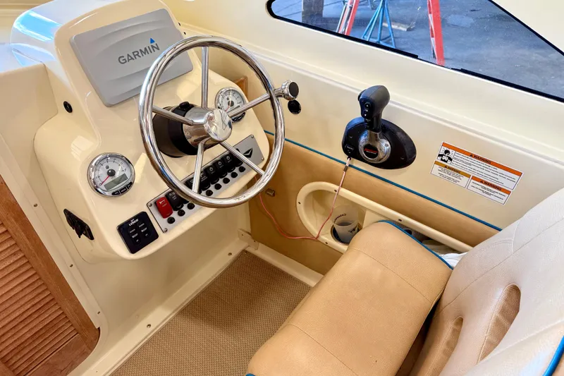 Slide: The Image of Interior of 2018 Vanquish Bristol Harbor 23 boat with steering wheel and Garmin navigation system. - 10