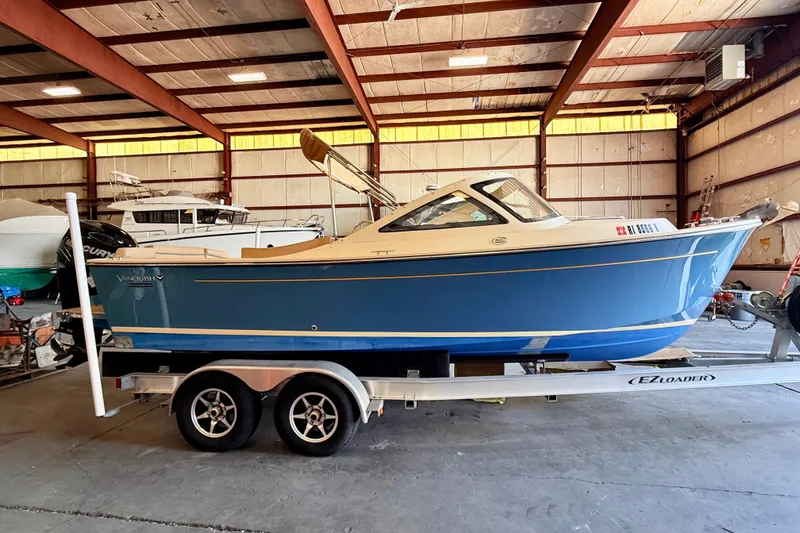 Slide: The Image of 2018 Vanquish Bristol Harbor 23 boat on trailer in indoor storage facility. - 2