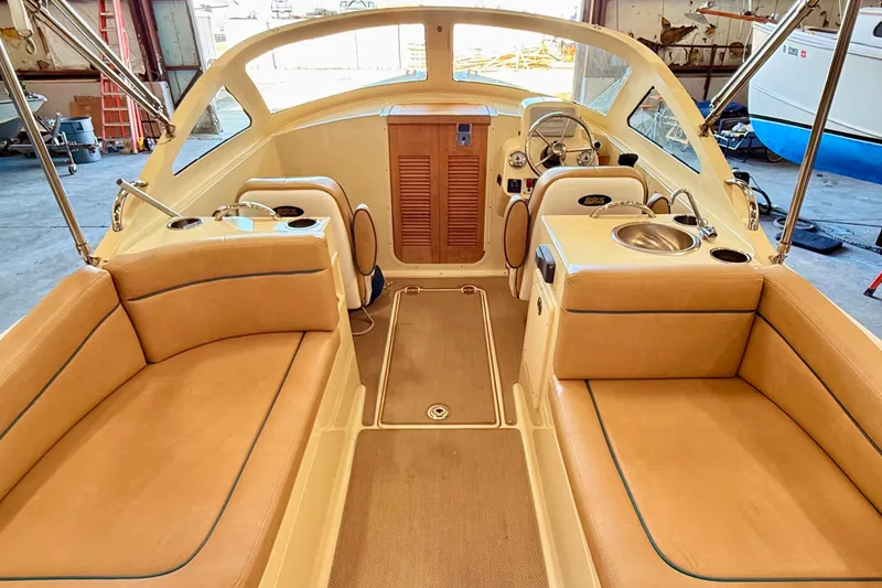 Slide: The Image of Interior of 2018 Vanquish Bristol Harbor 23 boat with tan seating and helm. - 7