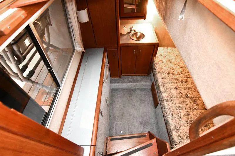 Slide: The Image of Interior of 1993 Bayliner 3288 Motoryacht with cozy cabin, sink, and wooden cabinetry. - 10
