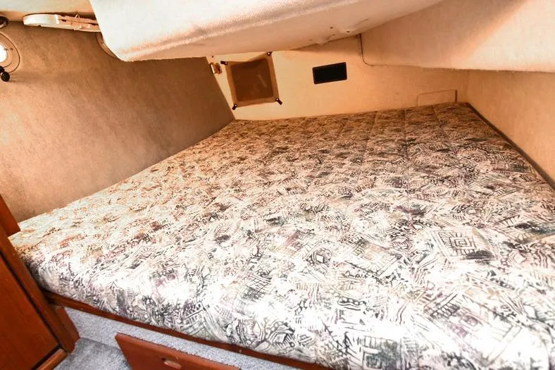 Slide: The Image of 1993 Bayliner 3288 Motoryacht cabin with patterned bed and cozy interior. - 11