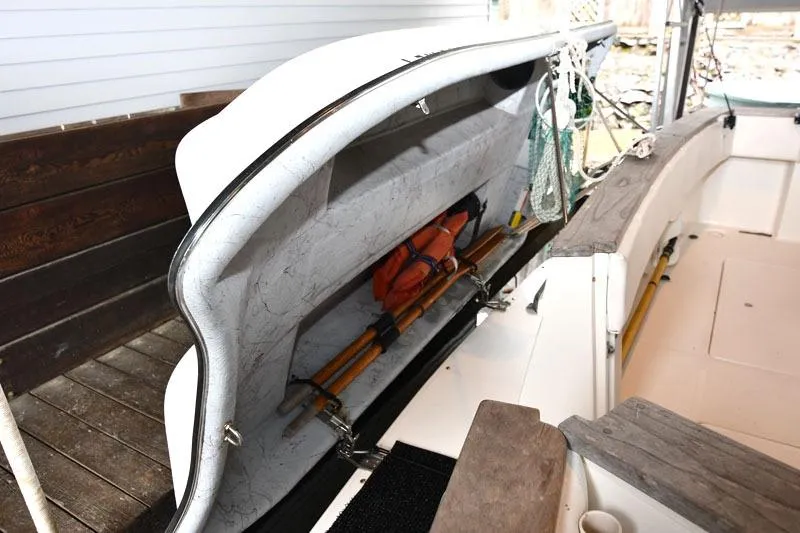 Slide: The Image of 1993 Bayliner 3288 Motoryacht storage compartment with life jackets and oars. - 13