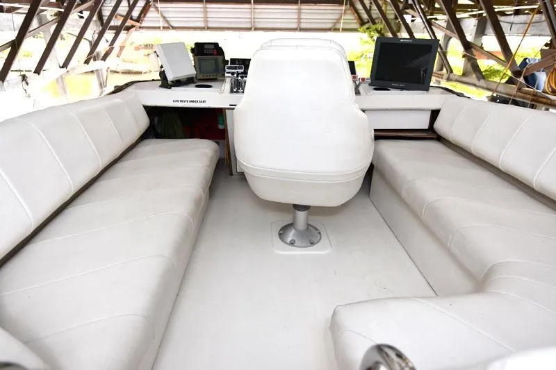 Slide: The Image of Interior of 1993 Bayliner 3288 Motoryacht with white seating and navigation equipment. - 14