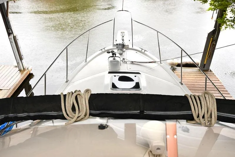 Slide: The Image of 1993 Bayliner 3288 Motoryacht docked, view from bow with ropes and deck details. - 16