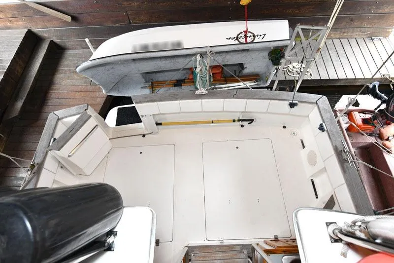Slide: The Image of Overhead view of 1993 Bayliner 3288 Motoryacht deck with docked dinghy. - 17