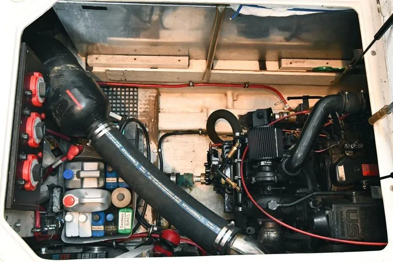 Slide: The Image of Engine compartment of a 1993 Bayliner 3288 Motoryacht, showcasing mechanical components and wiring. - 18
