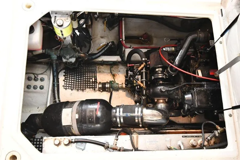 Slide: The Image of Engine compartment of a 1993 Bayliner 3288 Motoryacht, showcasing mechanical components and wiring. - 19