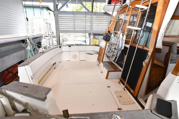 Slide: The Image of 1993 Bayliner 3288 Motoryacht cockpit with spacious seating and wooden accents. - 2