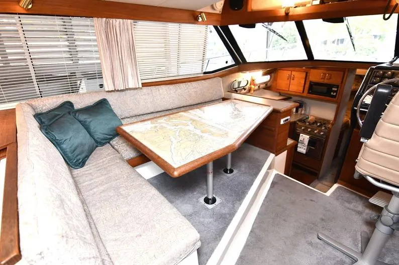 Slide: The Image of Interior of 1993 Bayliner 3288 Motoryacht with cozy seating and navigation table. - 6