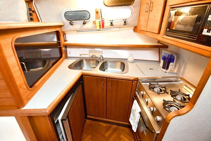 Slide: The Image of Kitchen area of a 1993 Bayliner 3288 Motoryacht with stove, sink, and microwave. - 8