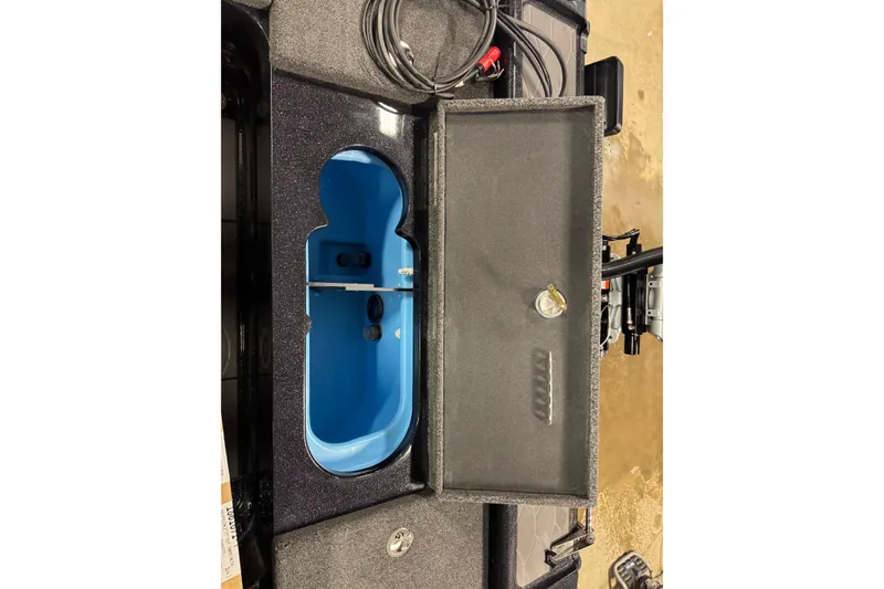 Slide: The Image of Interior view of 2026 Nitro ZV21 Pro boat storage compartment with blue lining and cables. - 11