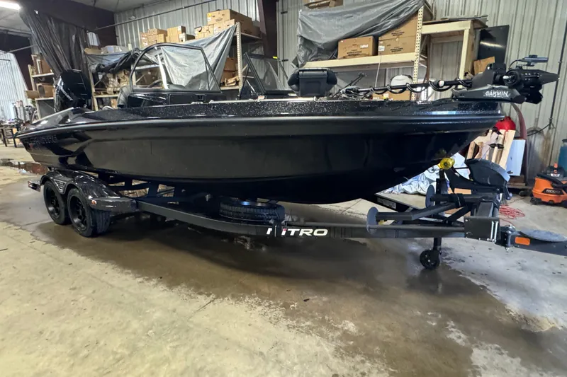 Slide: The Image of 2026 Nitro ZV21 Pro boat on trailer in a warehouse setting. - 2