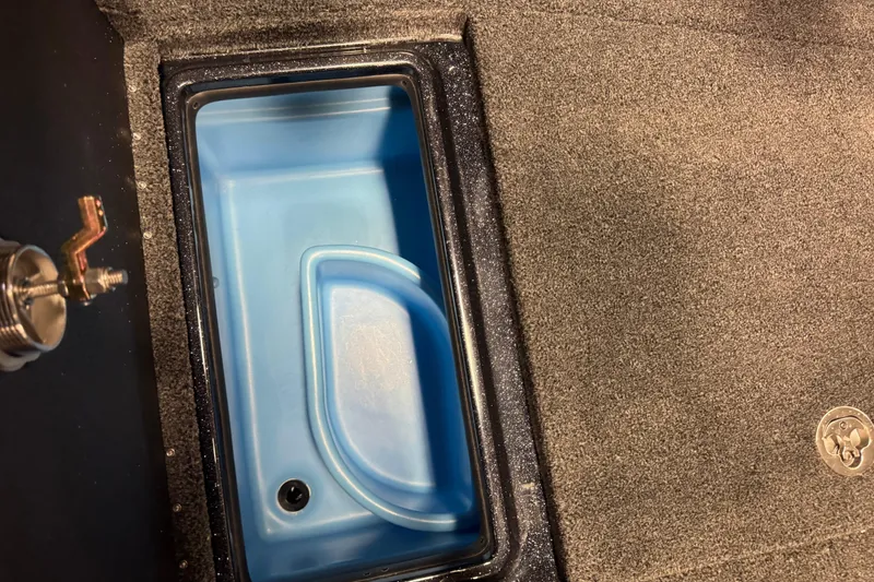 Slide: The Image of Interior compartment of 2026 Nitro ZV21 Pro boat with blue storage bin. - 22