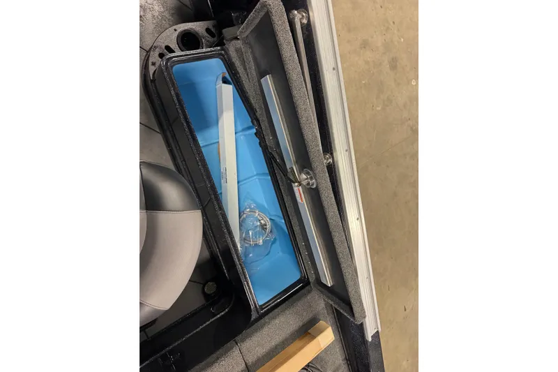 Slide: The Image of Interior storage compartment of 2026 Nitro ZV21 Pro boat, featuring blue lining and secure latch. - 9