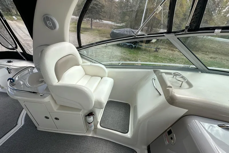 Slide: The Image of Captain's seat on a 2003 Sea Ray 340 Sundancer yacht, featuring a sleek, modern design. - 10
