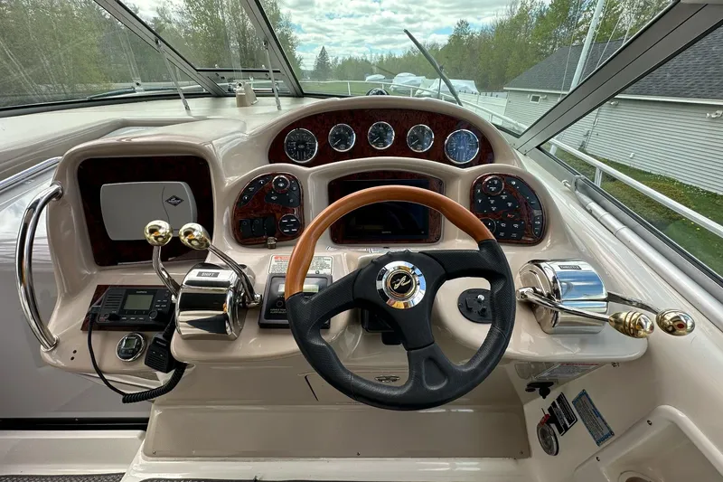 Slide: The Image of Helm of 2003 Sea Ray 340 Sundancer with steering wheel and control panel. - 13