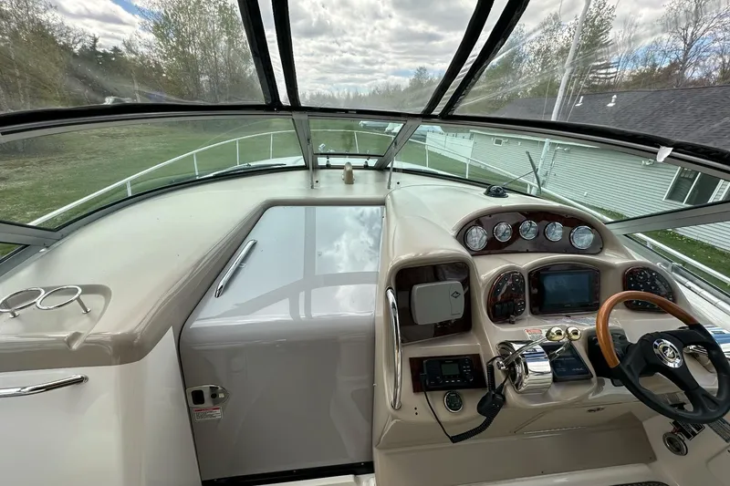 Slide: The Image of Cockpit view of 2003 Sea Ray 340 Sundancer with steering wheel and instrument panel. - 14