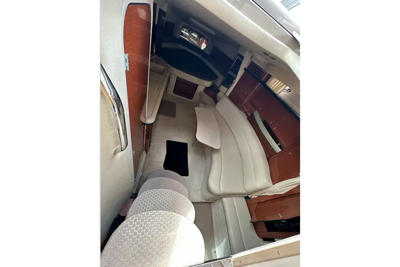 Slide: The Image of Interior of 2003 Sea Ray 340 Sundancer yacht, featuring seating and cabinetry. - 15