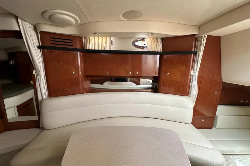 Slide: The Image of Interior of 2003 Sea Ray 340 Sundancer yacht with elegant wood cabinetry and plush seating. - 16