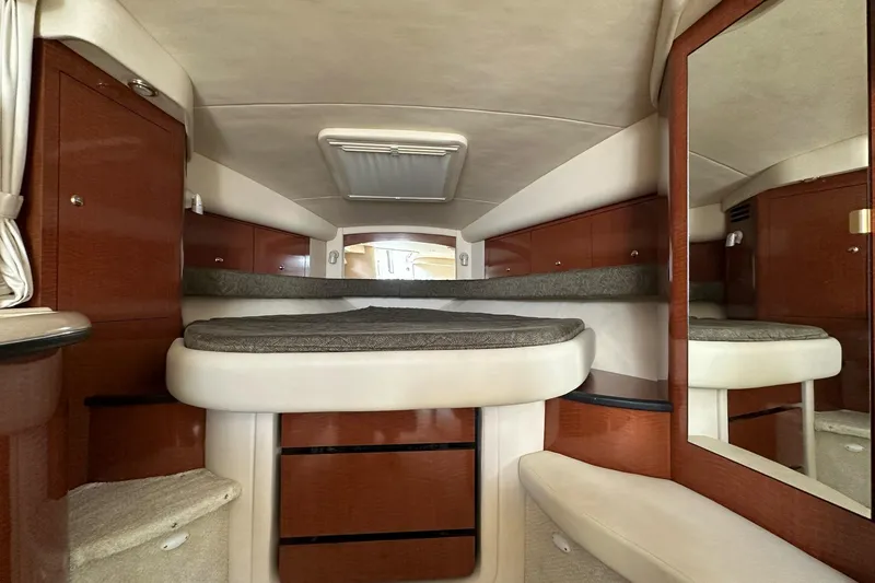 Slide: The Image of 2003 Sea Ray 340 Sundancer cabin interior with wood cabinetry and cushioned seating. - 18