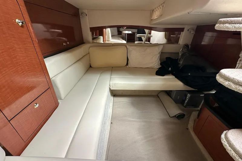 Slide: The Image of Interior cabin of 2003 Sea Ray 340 Sundancer with beige seating and wooden cabinetry. - 19