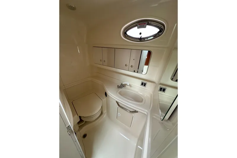 Slide: The Image of 2003 Sea Ray 340 Sundancer bathroom with sink, toilet, and storage cabinets. - 20