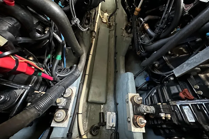 Slide: The Image of Engine compartment of a 2003 Sea Ray 340 Sundancer, showcasing wiring and mechanical components. - 26
