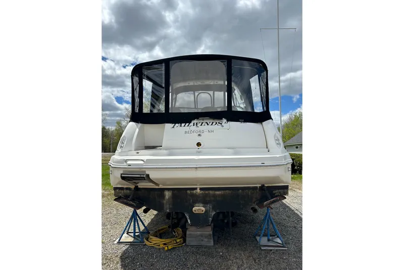 Slide: The Image of Rear view of a 2003 Sea Ray 340 Sundancer boat on stands under cloudy skies. - 4