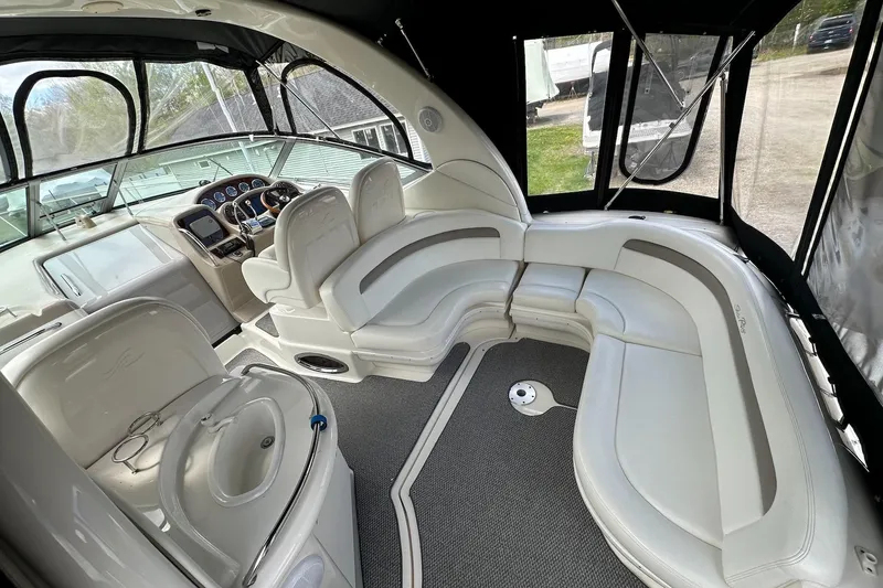 Slide: The Image of Interior of 2003 Sea Ray 340 Sundancer boat with white seating and helm. - 7