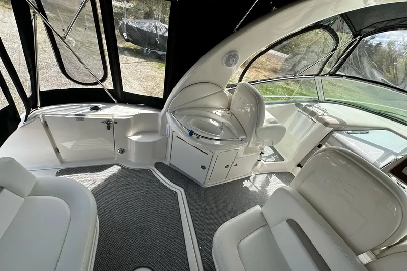 Slide: The Image of Interior of 2003 Sea Ray 340 Sundancer boat, featuring seating and helm area. - 8