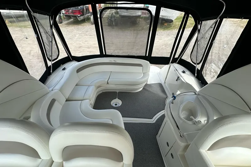 Slide: The Image of Interior of 2003 Sea Ray 340 Sundancer boat with white seating and enclosed canopy. - 9