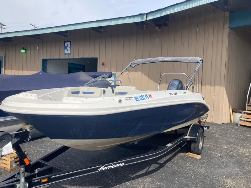 Slide: The Image of 2020 Hurricane SunDeck Sport 185 OB boat on trailer outside warehouse. - 4