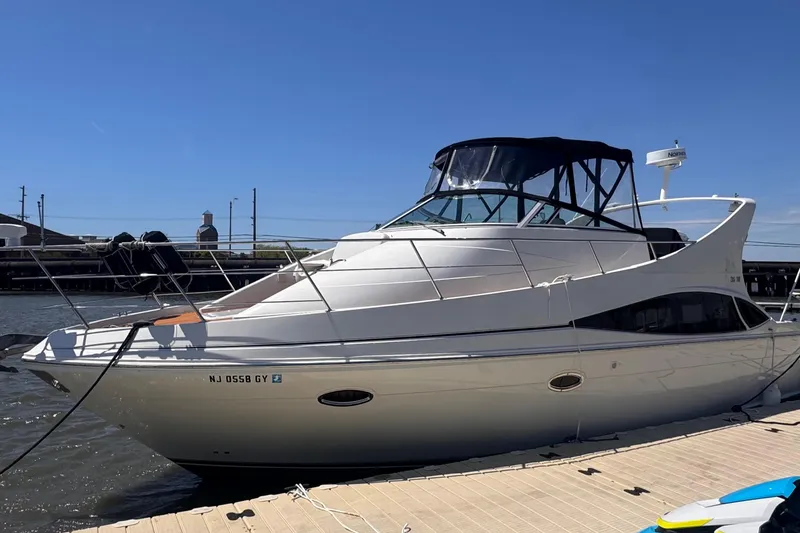 The Image of 2006 Carver 36 Mariner yacht docked at marina under clear blue sky. - 0