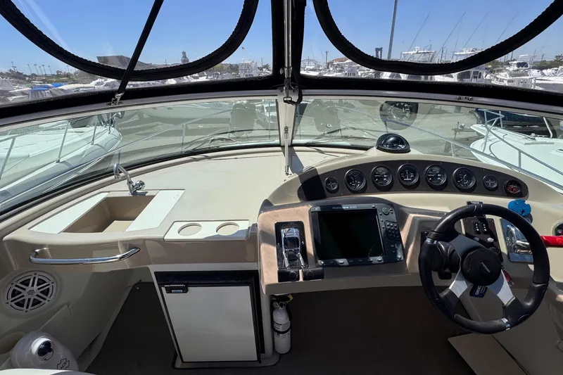 Slide: The Image of 2006 Carver 36 Mariner helm with steering wheel, navigation controls, and gauges. - 11
