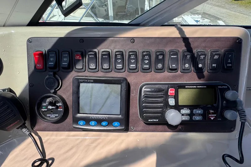 Slide: The Image of Control panel of a 2006 Carver 36 Mariner boat with navigation and communication equipment. - 13