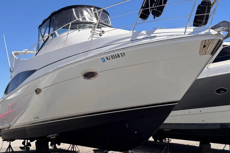 Slide: The Image of 2006 Carver 36 Mariner yacht on dry dock, showcasing sleek design and white hull. - 3