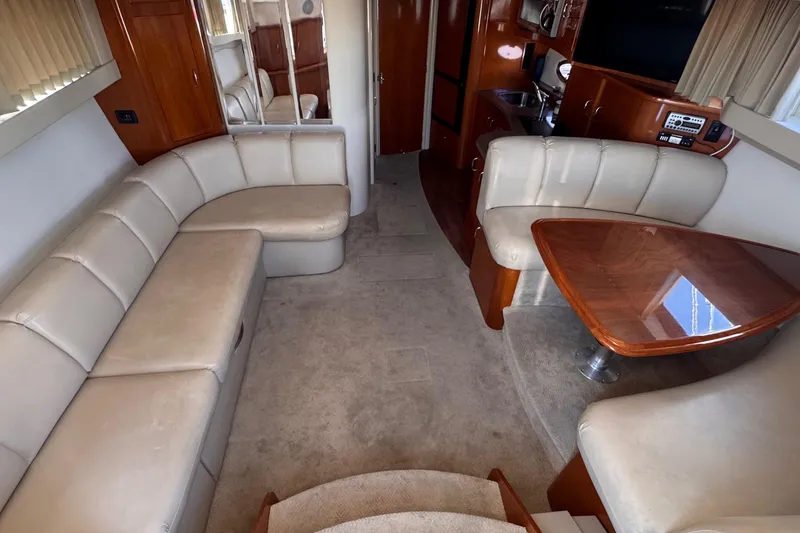 Slide: The Image of Luxurious interior of 2006 Carver 36 Mariner yacht with plush seating and wooden table. - 6