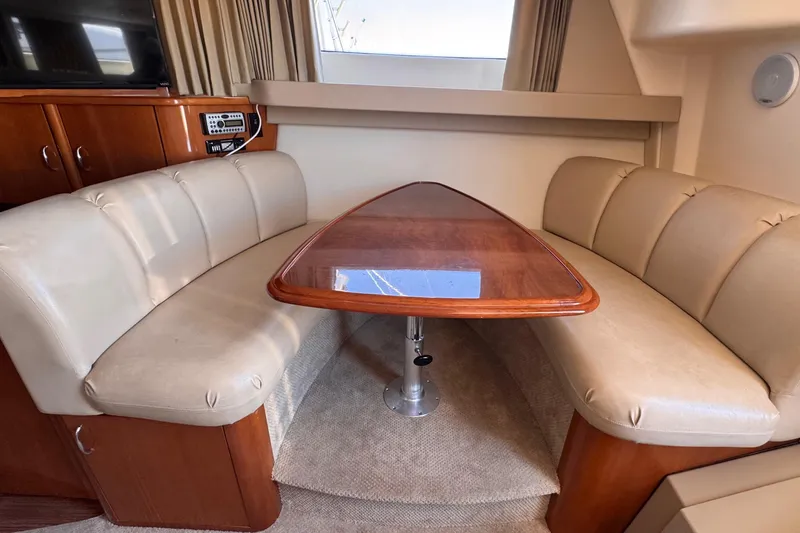 Slide: The Image of Luxurious interior of 2006 Carver 36 Mariner with plush seating and wooden table. - 8