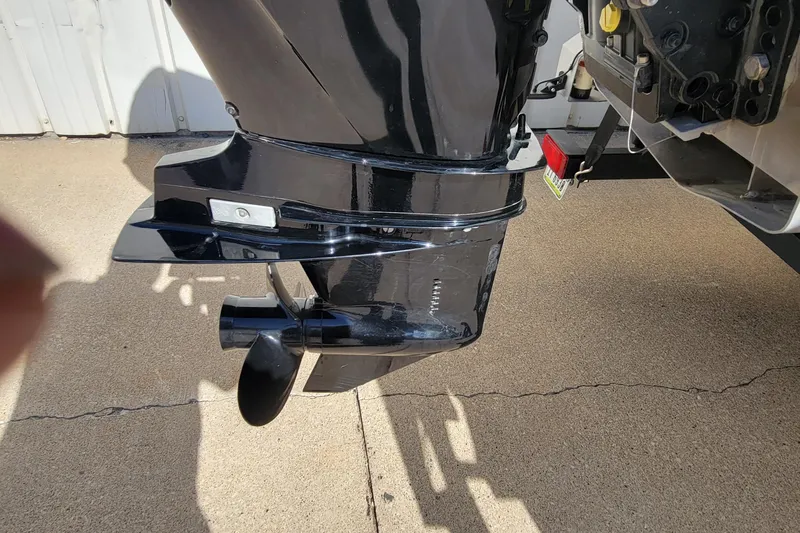 Slide: The Image of 2022 SUNTRACKER BASS BUGGY 16 XLS boat motor, black finish, on concrete surface. - 10