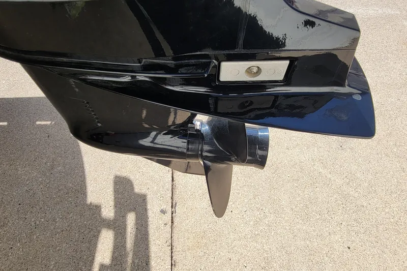 Slide: The Image of Close-up of a 2022 SUNTRACKER BASS BUGGY 16 XLS boat propeller on concrete. - 12
