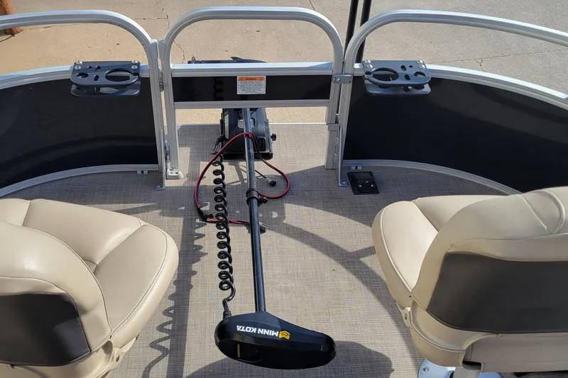 Slide: The Image of 2022 SUNTRACKER BASS BUGGY 16 XLS boat interior with seating and trolling motor. - 16