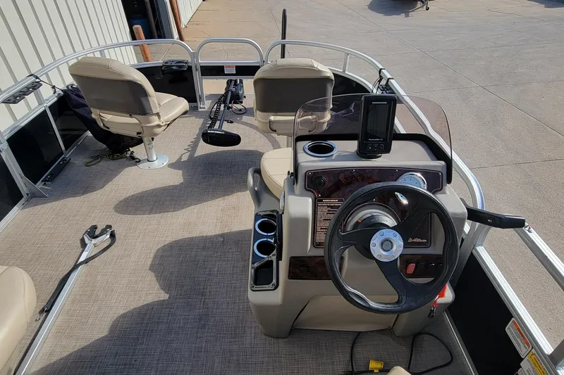 Slide: The Image of 2022 SUNTRACKER BASS BUGGY 16 XLS boat interior with steering console and seating. - 18