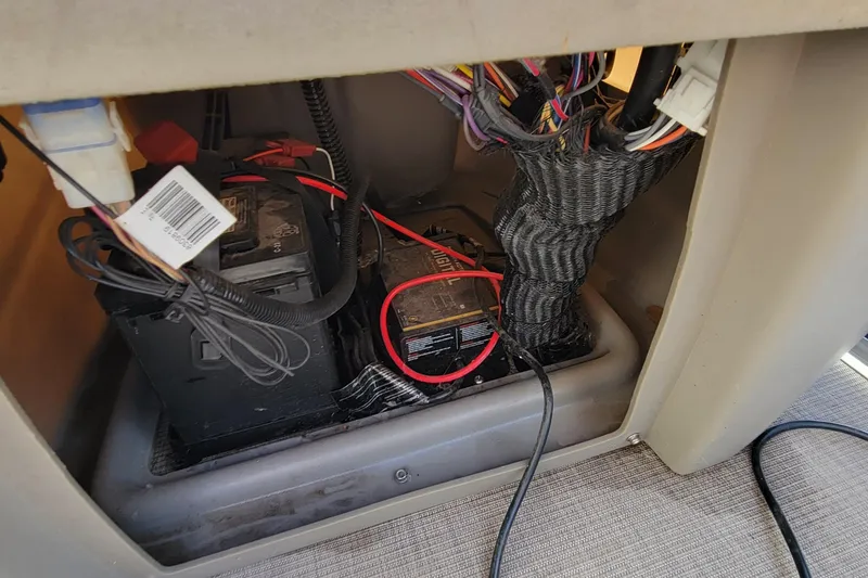 Slide: The Image of Battery compartment of 2022 SUNTRACKER BASS BUGGY 16 XLS with wiring and cables. - 22